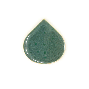 Green ceramic teardrop-shaped object on a white background
