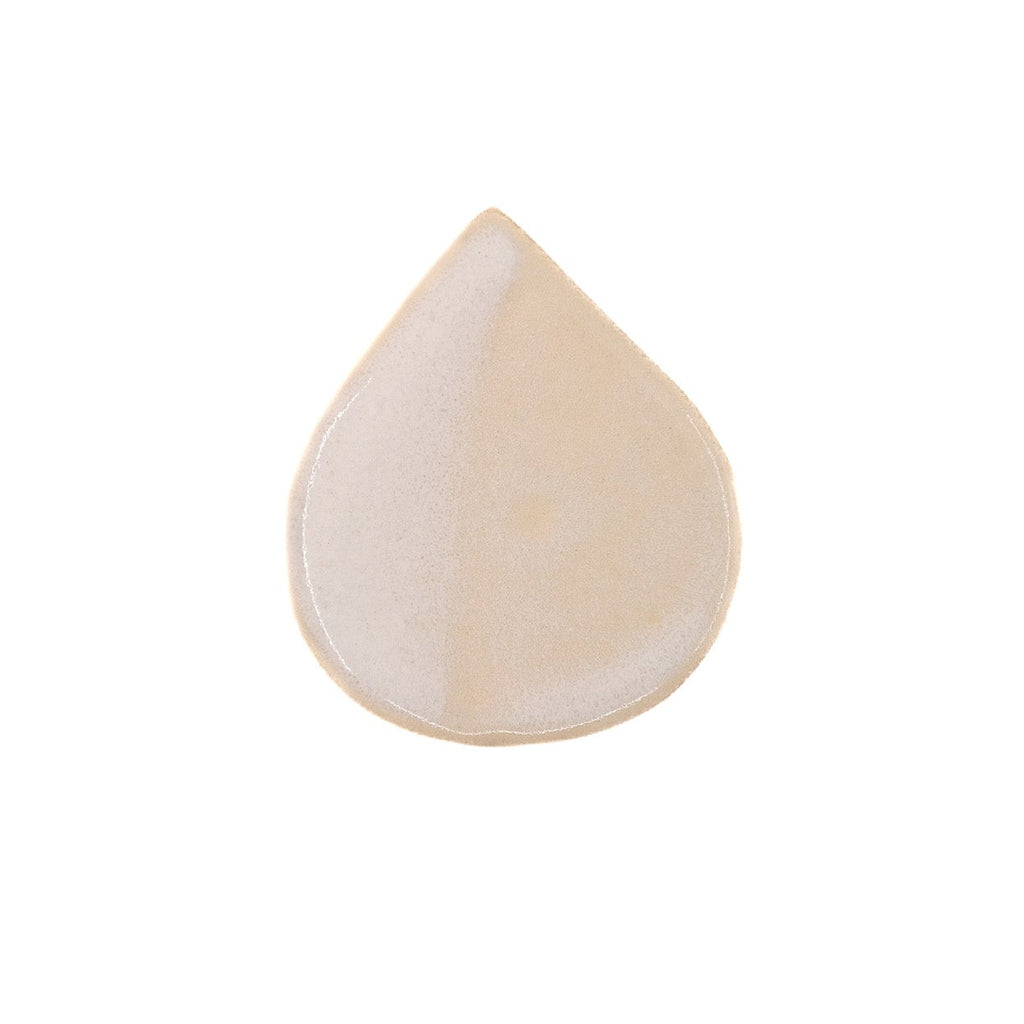 Beige teardrop-shaped object on a white background