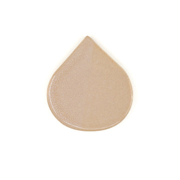 Beige teardrop-shaped tile on a white background
