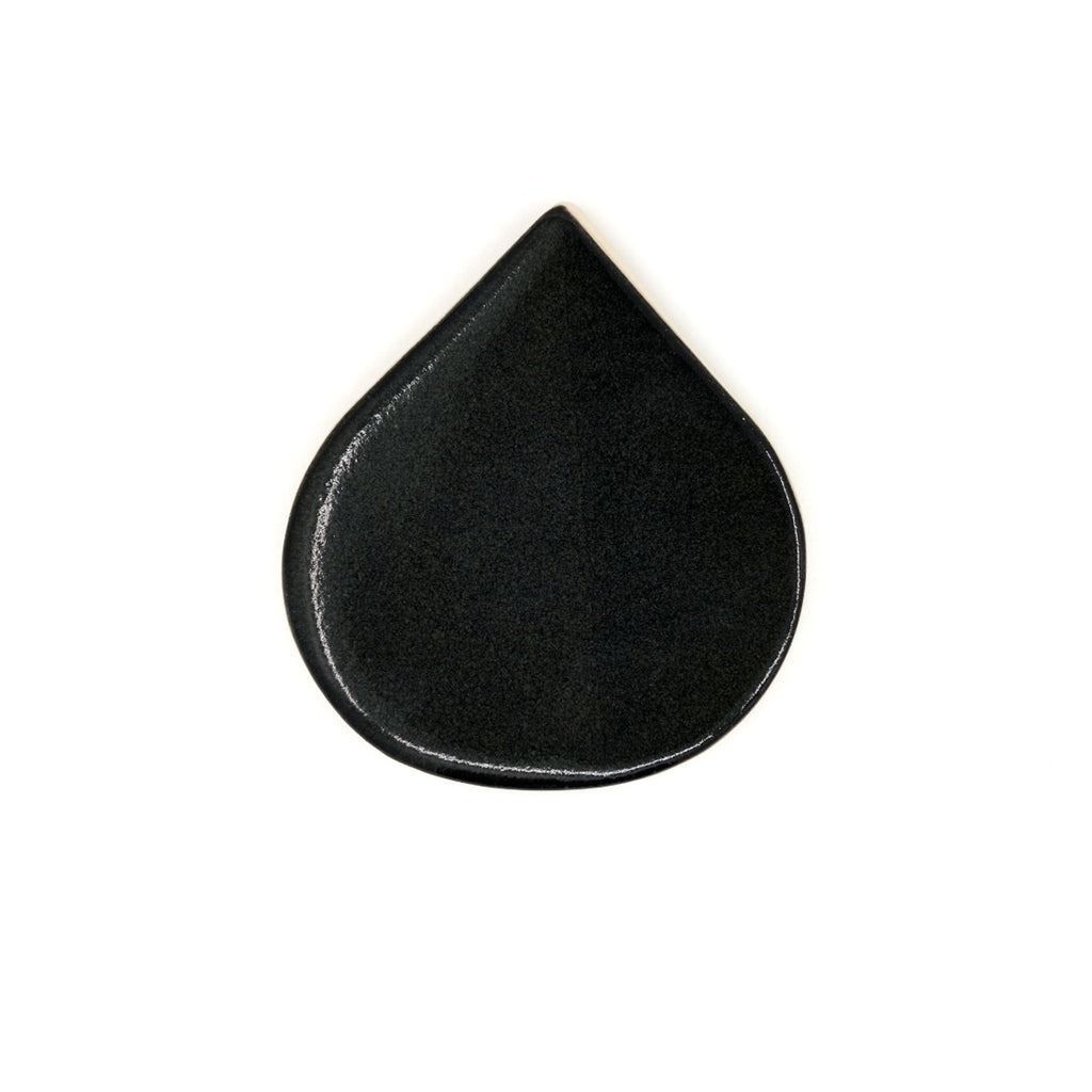 Black teardrop-shaped object on a white background
